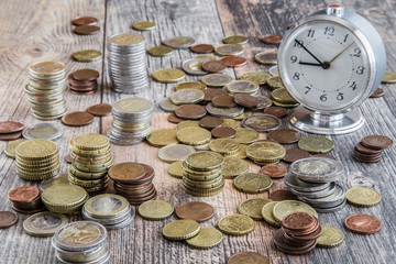 Money on the wooden table. Euro coin stocks from different countries.