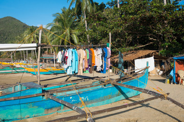 Fototapeta na wymiar Laundry hanging to dry on an old village fishing boat