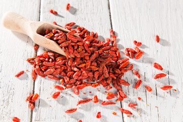 Dry goji berry on old white wooden background.