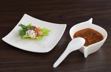 Nam Neung , Vietnamese food in white dish and sweet sauce all put on dark wooden table