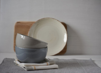 Fototapeta na wymiar Set of Porcelain Dishes. Kitchen Utensil. Rustic napkin and kitchen tools.