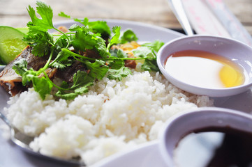 Vietnamese broken rice or com tam with fried chicken legs, pork and herbs