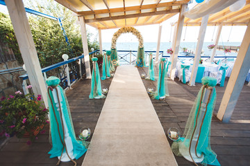 Wedding on the beach. Beautiful wedding arch, decorated with flowers. Sea. The ocean.