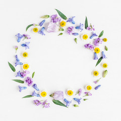Flowers composition. Wreath made of various colorful flowers on white background. Easter, spring, summer concept. Flat lay, top view