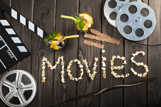 Top View Of Clapper Board, Drinks, Tickets And Movie Lettering On Table, Movie Time Concept