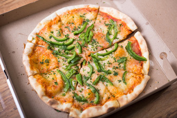 Italian pizza with green pepper in paper box tasty macro picture useful for background