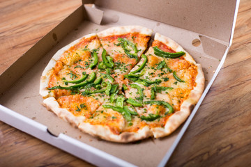 Italian pizza with green pepper in paper box tasty macro picture useful for background