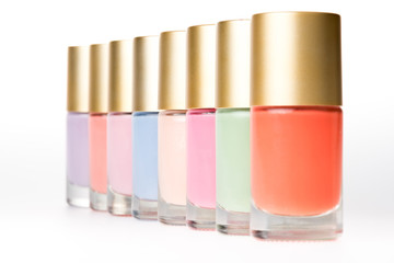 close up view of various colorful nail polishes on white