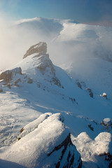 Fototapeta na wymiar rock covered with snow and fog