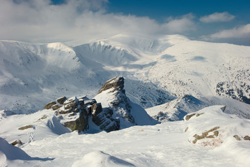rock covered with snow and fog