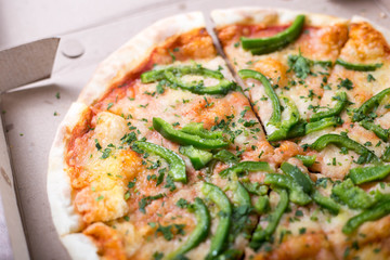 Italian pizza with green pepper in paper box tasty macro picture useful for background