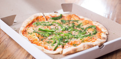 Italian pizza with green pepper in paper box tasty macro picture useful for background