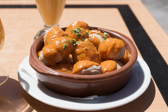 Canarian potatoes (boiled potatoes) with sauce on wooden table
