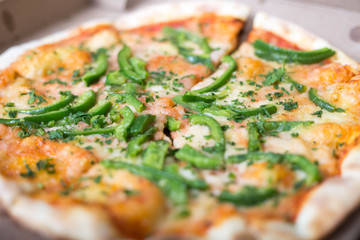 Italian pizza with green pepper in paper box tasty macro picture useful for background