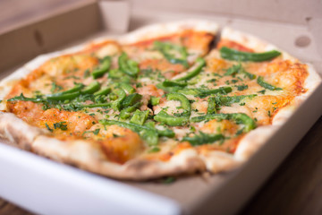Italian pizza with green pepper in paper box tasty macro picture useful for background