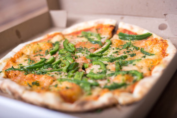 Italian pizza with green pepper in paper box tasty macro picture useful for background