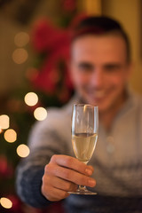 Happy young man with a glass of champagne