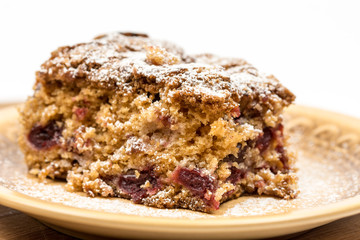 Cherry cake with powdered sugar on the plate