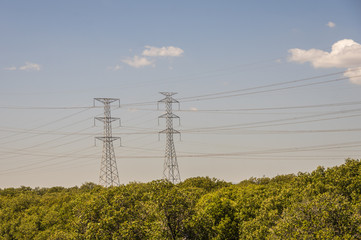 Electricity supply towers and structures transmit power along high voltage wires and cables