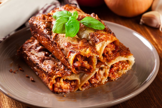 Baked cannelloni with minced meat and bechamel sauce on a plate
