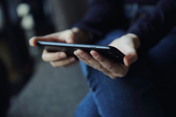 Asian female with hands typing text message