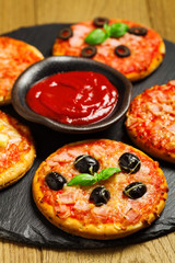 Mix of mini pizzas on a stone try