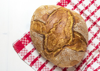 Selective focus baked bread isolated on red and white canvas