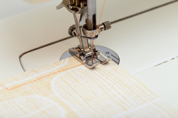 Sewing Machine Needle Stitching Orange Thread on Cloth