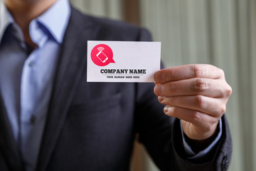 Businessman holding visit card. Man showing blank business card with company name text. Person in black suit. Mock up design.