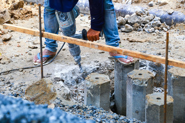 worker man mason drilling cement concrete floor with machine