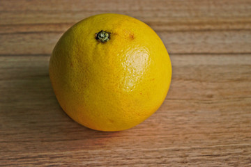 Yellow grapefruit on a wooden table