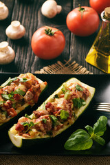Zucchini stuffed with minced meat, cheese and mushroom. Baked in oven.