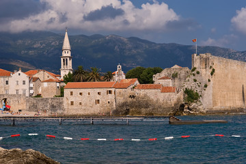 View of Old Town (Stari grad), ancient city walls, church and Citadel of Budva, Montenegro. Popular resort of Mediterranean, Adriatic Riviera. Holiday, vacation in Europe