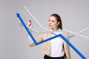 Businesswoman working with growth graph on grey background