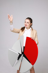 Woman shows a pie chart, circle diagram. Business analytics concept.