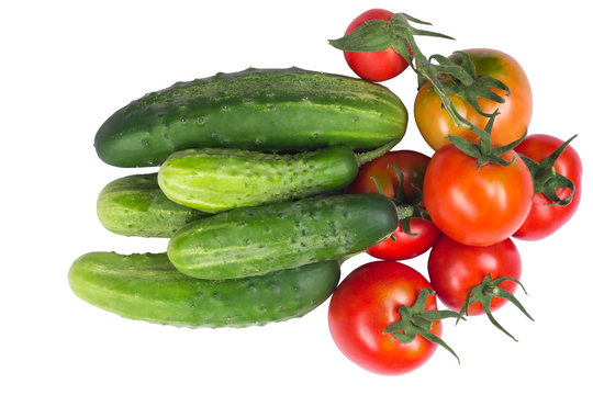 Tomatoes with cucumbers in a heap on white