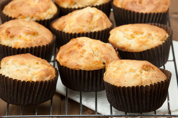 Homemade Cheddar Muffins In Paper Cases. Wooden Table.