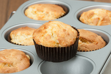Homemade Cheddar Muffins In Baking Tray. Wooden Table.