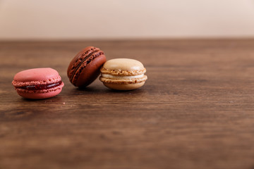 Macaroon cakes. Different types of macaron. Colorful almond cookies. French sweet dessert. Wooden rustic board.