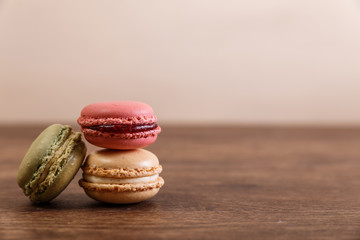 Macaroon cakes. Different types of macaron. Colorful almond cookies. French sweet dessert. Wooden rustic board.