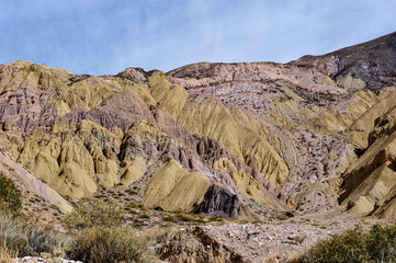 Coloured rock mountains. Hill of Seven Colors over Purmamarca village. Quebrada de Humahuaca valley, a UNESCO World Heritage Site, Argentina.