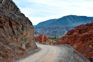 Coloured rock mountains. Hill of Seven Colors over Purmamarca village. Quebrada de Humahuaca valley, a UNESCO World Heritage Site, Argentina.