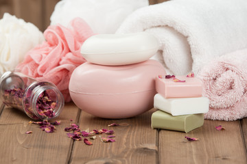 Obraz na płótnie Canvas Soap Bars, Towels, Wisps. Body Care Kit. Dried Rose Petals.