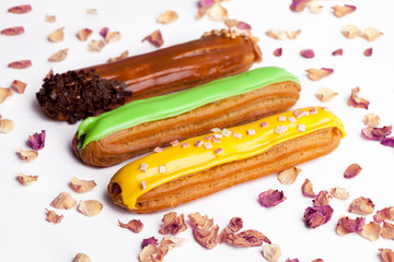 Group French dessert Eclair on a gray background plate.