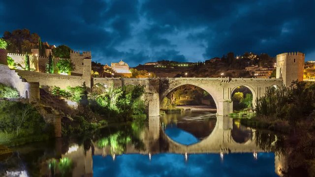 Saint Martin Bridge (Puente de San Martin) at night in Toledo, Castilla-La Mancha, Spain (static image with animated sky and water)
