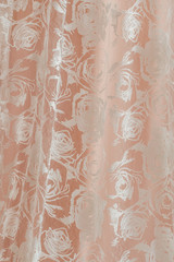 Embroidered roses in beige background. Cloth