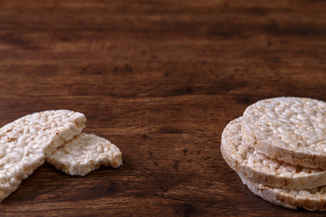 Rice biscuits on grunge rustic wood background. Natural organic diet food. Wooden vintage board.