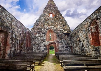 Interior of an old roofless church ruins on a beautiful sunny mid-summer day in Finland.