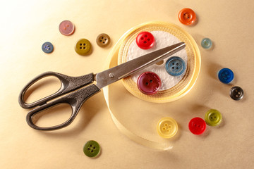 Colourful buttons, scissors and ribbon roll