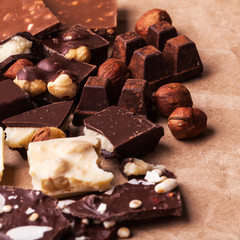 Variety of sweet homemade chocolate pralines on wooden background